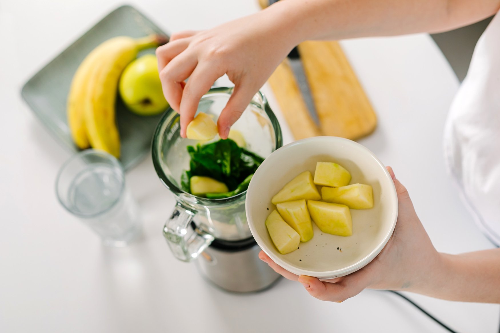 Process of Preparing Green Detox Smoothie with Blender. Vegan Drinks. Concept of Mindful Eating